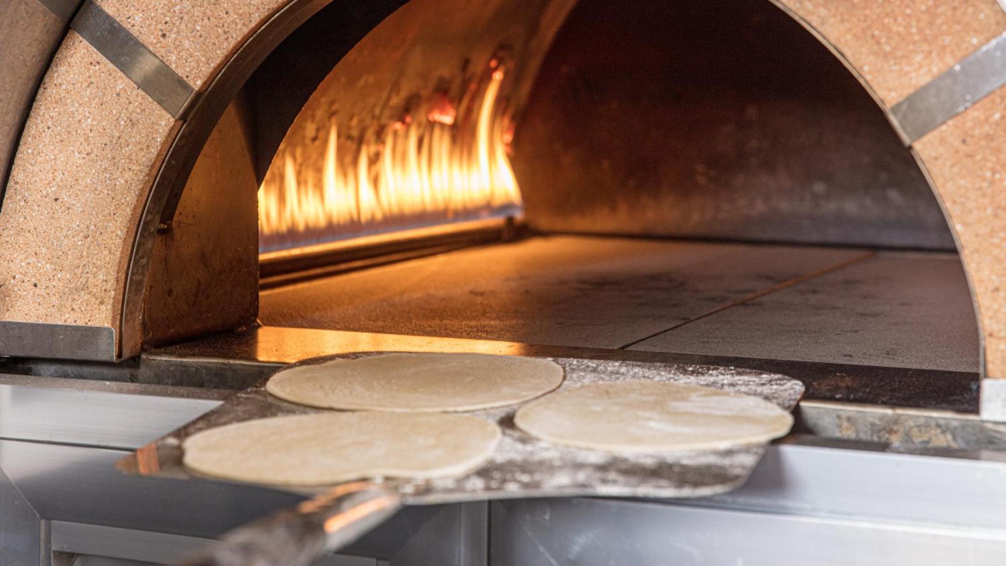 The Abdali Boulevard Hotel Amman Ngoại thất bức ảnh Pizza dough in a wood-fired oven